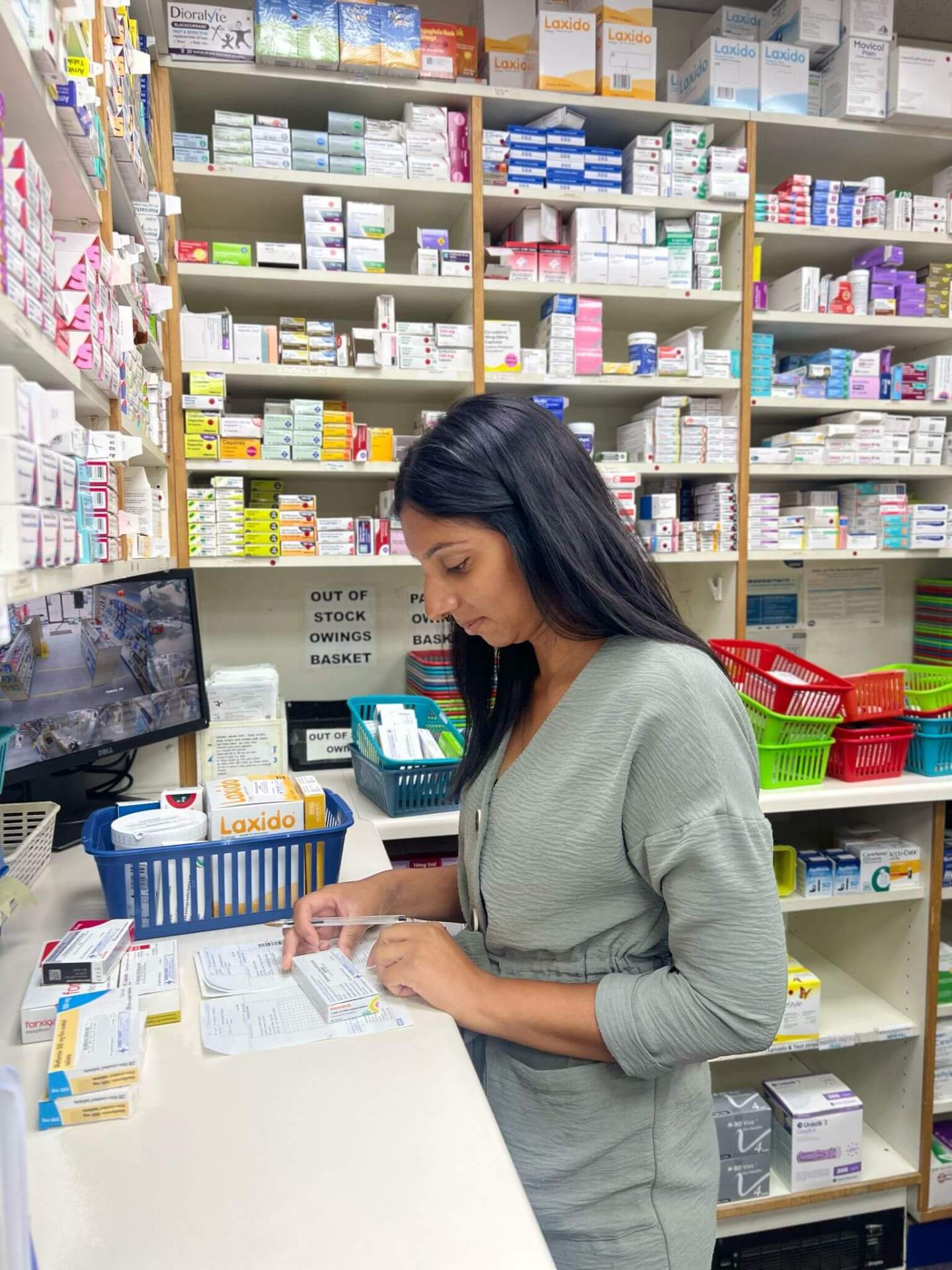 Pharmacist checking prescriptions at Garner Chemist
