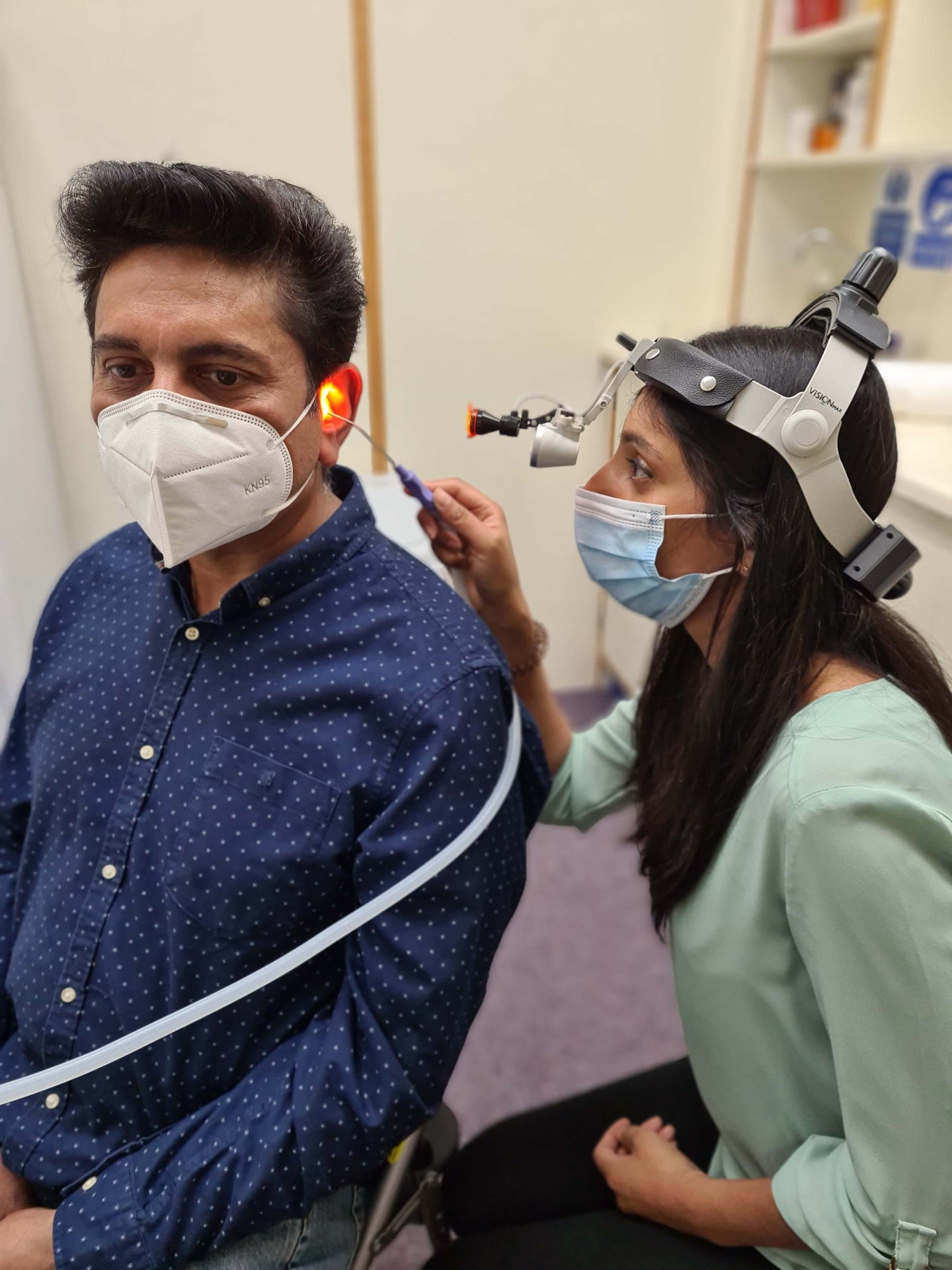 Clinician performing microsuction ear wax removal on a patient at Garner Chemist Harrow